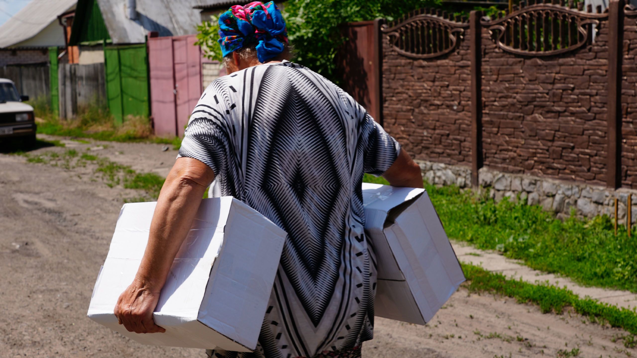 A woman receives food distribution in a front-line town outside the northern city of Kharkiv.